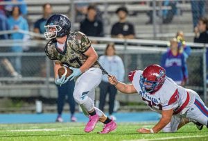Burrell’s Trey Coury is held up by Mt. Pleasant’s Carter Strayer late in the fourth quarter Friday, Sept 5, 2025, at Burrell.