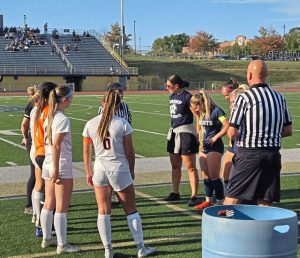 Latrobe (left) and Norwin girls soccer players meet with officials before their game Wednesday.