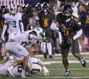 Central Catholic’s Roman Thompson carries through the Pine-Richland defense on Aug. 29.