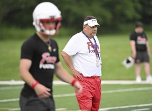 Fox Chapel coach Dave Leasure looks on as quarterback Joey Geller throws against Armstrong during 7-on-7 play in July.