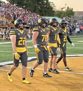 North Allegheny captains head to midfield for the coin toss before their game against Hempfield on Sept. 12, 2025, at North Allegheny.