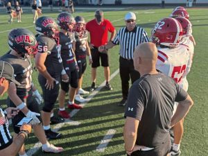 Players from Moon and West Allegheny meet for the coin toss before their game Sept. 12, 2025, at West Allegheny.