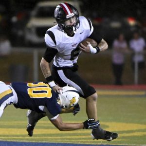 Aliquippa’s Joseph Work carries against Mars’ Gabe Hein on Friday in Adams.