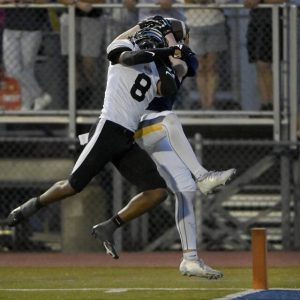 Mars’ Gabe Hein catches a touchdown pass as Aliquippa’s Akiva Woods defends during the second quarter on Friday, Sept. 12, 2025, in Adams.