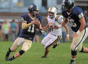 Freeport’s Ryan Weigold eludes an Apollo-Ridge defender on Sept. 18, 2015 at Swartz Memorial Stadium. Weigold passed for 195 yards and three touchdowns in a 42-6 Yellowjackets win.