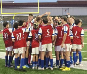 Mt. Pleasant boys soccer players break a huddle to start the second half Tuesday night against Southmoreland at Viking Stadium.