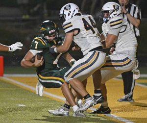 Norwin’s Santino Brasco (44) and Josh Lenart sack Penn Trafford quarterback Nate Desmond on Aug. 22.