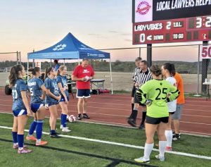 Mt. Pleasant (left) and Yough girls soccer players meet with officials before Wednesday night's game in Mt. Pleasant.