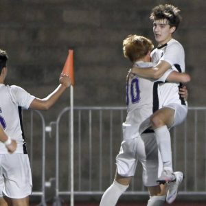 Plum’s Christian Alter is hoisted in the air by Hudson Strasser after the two combined to score in the final minutes of their game against Norwin on Thursday, Sept. 18, 2025, at Norwin.