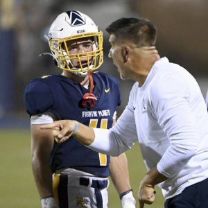 Mars’ Ayden Yocum talks with head coach Eric Kasperowicz during their game against Aliquippa on Friday, Sept. 12, 2025, in Adams.