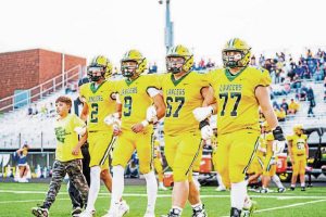 Marco Mangieri (left), with brothers Luca and Dante Mangieri and fellow captains Joey Ashi and Shaun Bier, take the field for the coin toss before Deer Lakes’ game with Derry on Sept. 5.