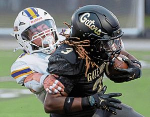 Gateway's Shawn Moorefield Jr. (3) is dragged down from behind by Plum's Landon Ekiert (4) on Friday, Sept. 5, 2025, at Gateway.