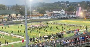 Players from Kiski Area and Penn-Trafford gather on the field for the national anthem before their game Sept. 19, 2025, at Warrior Stadium.