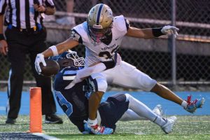 Freeport’s Amos Glenn (33) stretches the ball for a touchdown against Burrell Friday.
