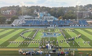 Members of the Canon-McMillan marching band take the field before Mt. Lebanon and Canon-McMillan play Sept. 19, 2025, at Canon-McMillan.