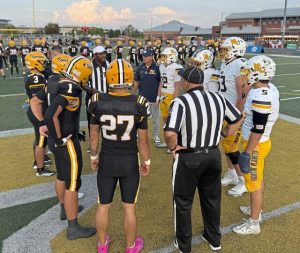Players from Mars and Montour head to midfield for the coin toss before their game Sept. 19, 2025, at Montour.