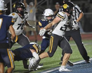 North Allegheny’s Luke Rohan plows into the end zone past Norwin defenders for the winning score Friday.