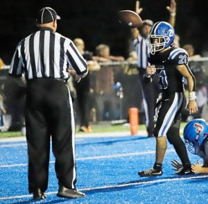 Leechburg’s Timmy Andrasy flips the ball to the official after scoring his second rushing touchdown against Jeannette on a 1-yard run in the second quarter Friday.