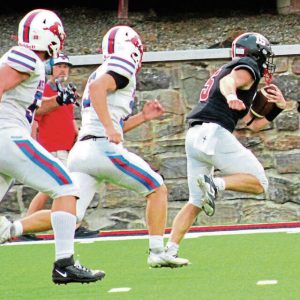 Southmoreland quarterback Dawson Wolfe races down the sideline for a big gain with Laurel Highlands defenders in pursuit during the first quarter Sept. 5 at Russ Grimm Stadium. Wolfe scored on a 2-yard run on the next play.