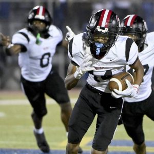 Aliquippa’s QaLil Goode returns an interception for a touchdown in the final seconds to seal the Quips’ victory over Mars on Sept. 12.