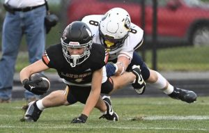 Latrobe’s Sawyer Butina stretches the ball past Norwin’s Michael DeFazio on Sept. 5.