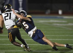Norwin punter Evan Pfeifer causes North Allegheny’s Korry Pitts to fumble out of bounds last Friday.