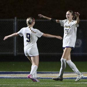 Plum’s Gianna Revetta (9) celebrates with Emily Grubich after scoring against Franklin Regional on Monday.