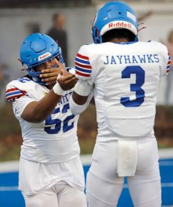 Jeannette junior offensive lineman Isaiah Jones celebrates with quarterback Kymon’e Brown after Brown scored on a 36-yard touchdown run Sept. 19 at Leechburg.
