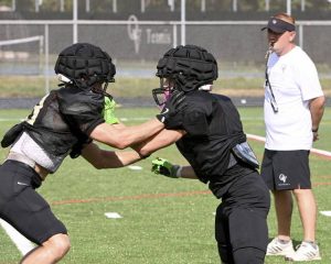 Quaker Valley’s Ben McHenry (left) battles Logan Benedict during a preseason practice at Chuck Knox Stadium in Leetsdale.