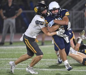 North Allegheny’s Cameron Kushner puts a hit on Norwin’s Giovanni Rothrauff on Sept. 19 at Norwin High School.