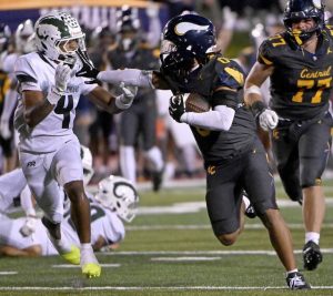 Central Catholic’s Roman Thompson stiff-arms Pine-Richland’s Jay Timmons during the third quarter on Friday, Aug. 29, 2025, at CMU.