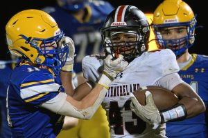 Southmoreland’s Averyon Darnell (43) stiff-arms Derry’s Karsen Weiers (11) on Friday.