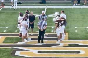 Elizabeth Forward (left) and Greensburg Salem players take part in the coin toss before playing Friday.