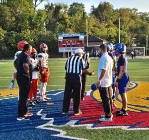 Captains for Jeannette and Clairton meet at midfield for the coin toss before their game Sept. 26, 2025, at Jeannette.