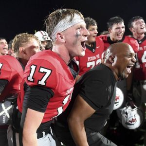 Peters Twp. quarterback Nolan DiLucia celebrates with his team after defeating Upper St. Clair on Friday, Sept. 26, 2025, at Peters.