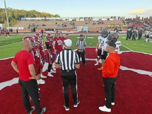 Captains for Bethel Park and Moon meet at midfield for the coin toss before their game Sept. 26, 2025, at Moon.
