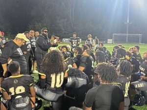 LaRoi Johnson talks with his Imani Christian players after beating North Catholic on Sept. 26, 2025, at UPMC Graham Field.