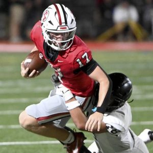 Peters Twp. quarterback Nolan DiLucia carries against Upper St. Clair’s Randy Yan on Friday, Sept. 26, 2025, at Peters.