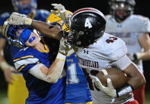 Southmoreland’s Averyon Darnell (43) stiff-arms Derry’s Karsen Weiers (11) on Friday.