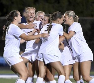 Mars’ Jade Breese is mobbed by teammates after scoring against Hampton on Aug. 27.