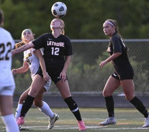 Latrobe’s Emerson Shine head a ball against Penn-Trafford last season.