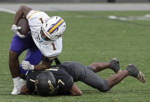 Plum’s Charles Hart (1) runs through an attempted tackle by Gateway’s Evan Woods on Sept. 5.