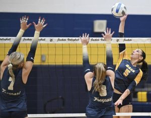 Mars’ Rylee Wooldridge hits against Freeport’s Payton Woods (7) and Jaisa Gaillot on Sept. 23.