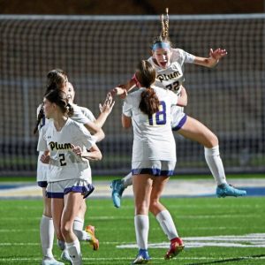 Plum’s Allison Porter (22) celebrates with Olivia Bigger after the Mustangs scored against Franklin Regional on Sept. 22.