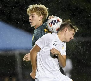 Deer Lakes’ Colton Bish battles Shady Side Academy’s Beau Brush for a header in the rain Aug. 28.