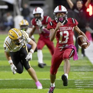 New Castle quarterback Marino Graham carries down the sideline past Montour’s Dominic Baron during the fourth quarter on Friday, Oct. 3, 2025, at Taggart Stadium.