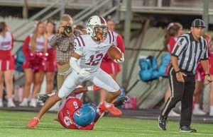 Greensburg Central Catholic’s Samir Crosby breaks the tackle of Jeannette’s Anthony Stuchell and runs for a touchdown Friday.
