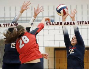 Aubrey Blank, right, gets a hand on an attempted kill by Fox Chapel's Emma DiRicco during a girls volleyball match Sept. 9, 2025 at Shaler. Sophie Spynda, left, was assisting on the block for the Titans.