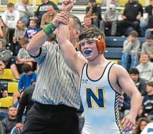 Norwin freshman Landon Sidun has his arm raised after winning the 114-pound title at the Powerade Wrestling Tournament on Dec. 30, 2023.