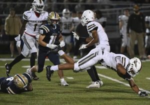 Highlands’ Tevin Owen-Cratsenberg dives for extra yardage past Freeport’s Luke Selinger last Friday.